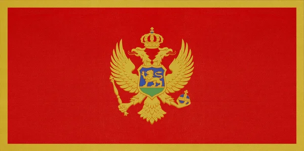 Černá Hora národní textilní vlajka, textilní pozadí. Symbol světové evropské země. — Stock fotografie