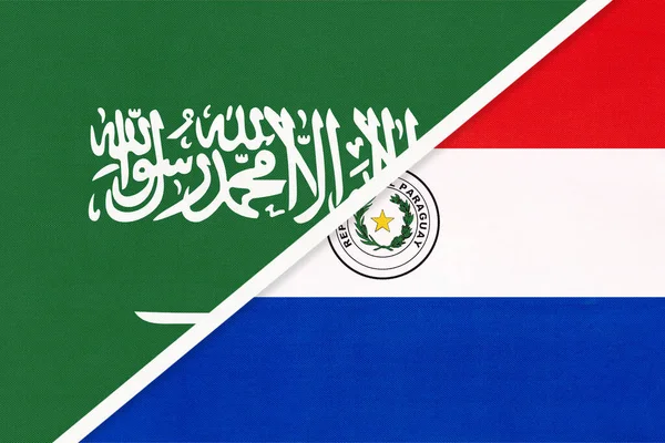 Saudi Arabia and Paraguay, symbol of two national flags from textile. Relationship, partnership and championship between Asian and American countries.