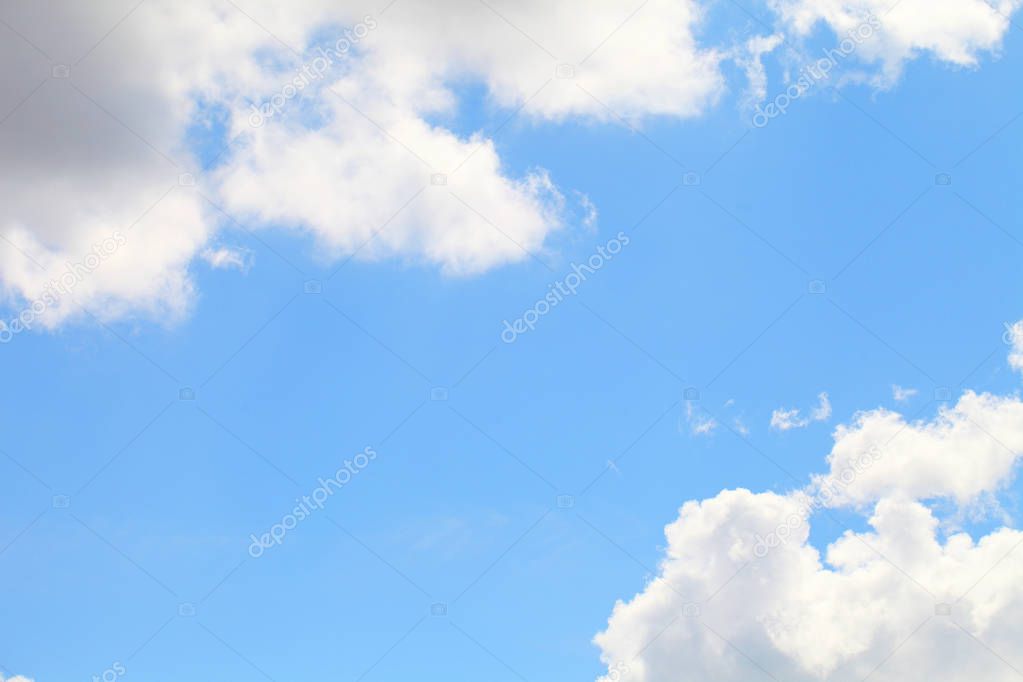 Blue sky with white beautiful clouds. The texture of natural phenomena, cloudiness on a clear sunny day.