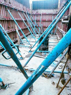 Mavi iskeleli ve beyaz kasklı bir inşaat alanı. Miğfer etiketli.