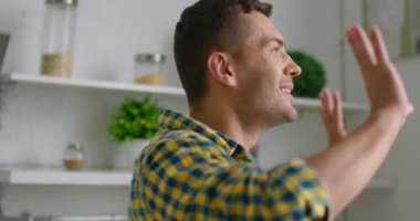 Genç adam modern bir mutfakta dans ediyor
