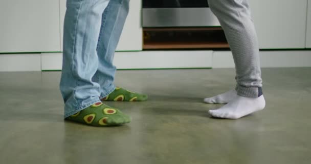 Закройте ноги молодая женщина и мужчина танцуют на кухне — стоковое видео