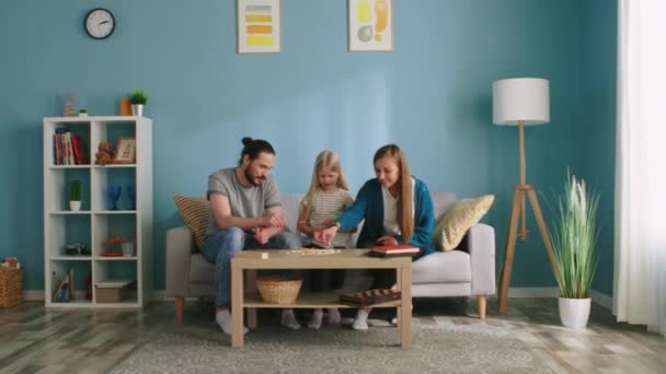 Family Plays Funny Board Game on Weekend — Stock video