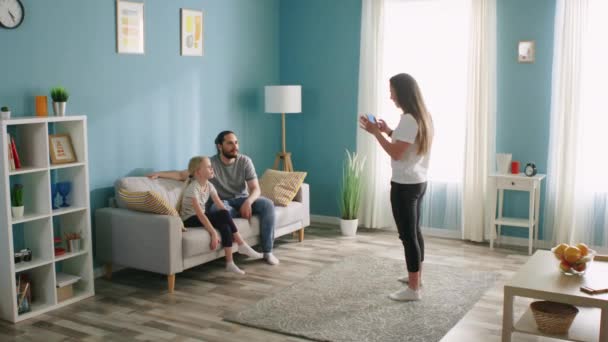 Couple and Small Girl Entertain in Living Room — Stock Video