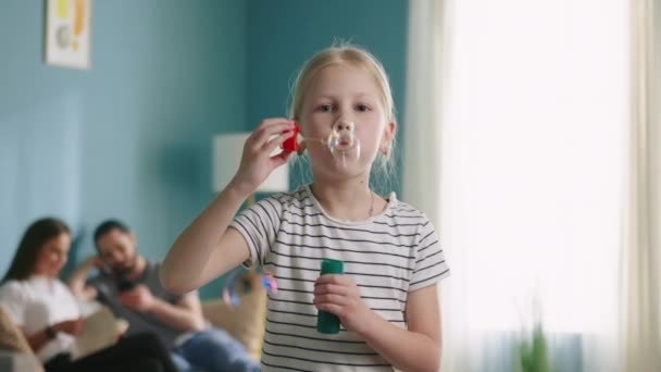 Alegre pequeno menina é soprando bolhas — Vídeo de Stock