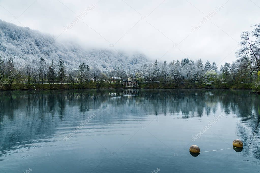 Cloudy view of Blue lake and forest in Upper Balkaria, Kabardino