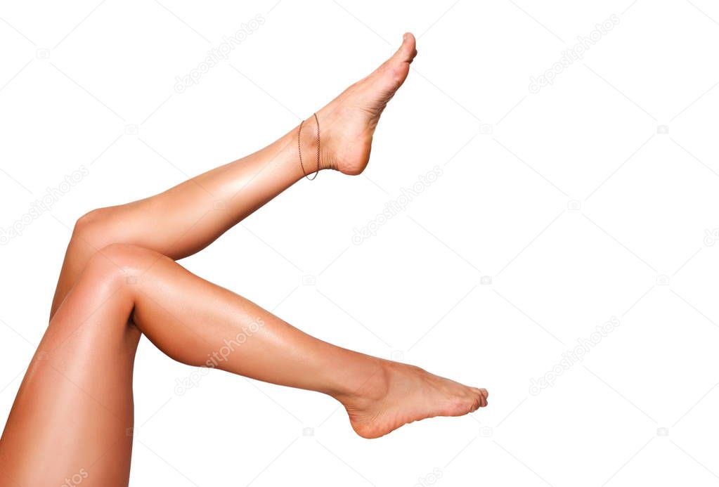 Beautiful smooth woman's legs after laser hair removal on the white background