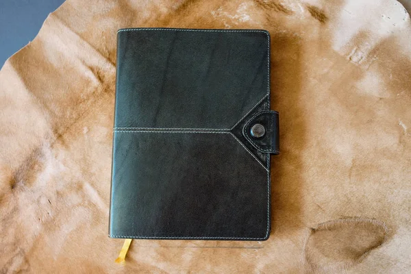 leather handmade notebook (organizer) on leather and fur background