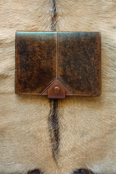 leather handmade notebook (organizer) on leather and fur background