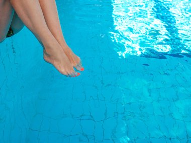 yüzme havuzunda sualtı turuncu ultraviyole pedikür ile yetişkin beyaz kafkas europian kadın bacakları. Yaz. Tatil ve spor konsepti.