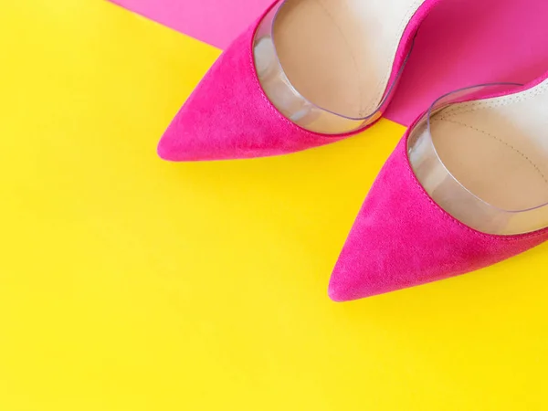 stylish pink high heels shoes on yellow and pink background. Shoes, fashion, style, shopping, sale concept