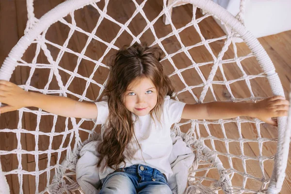 Очаровательная Веселая Маленькая Девочка Белой Футболке Джинсах Стильном Крытом Кресле — стоковое фото