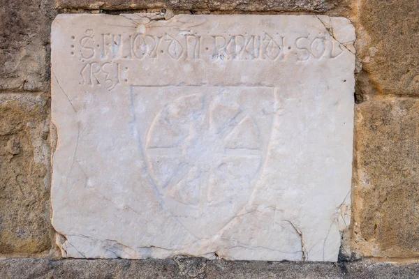 Marble inscription to the convent of San Francesco Roman Catholic church in Gothic style in the medieval village of Colle di Val d\'Elsa, Siena, Tuscany