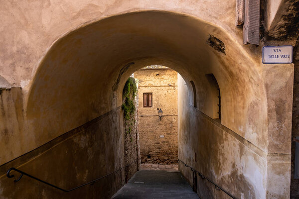 Stairway next to Via delle Volte, a covered road more than a hundred meters long, inside the well-preserved medieval urban structure of Colle di Val d'Elsa, Siena