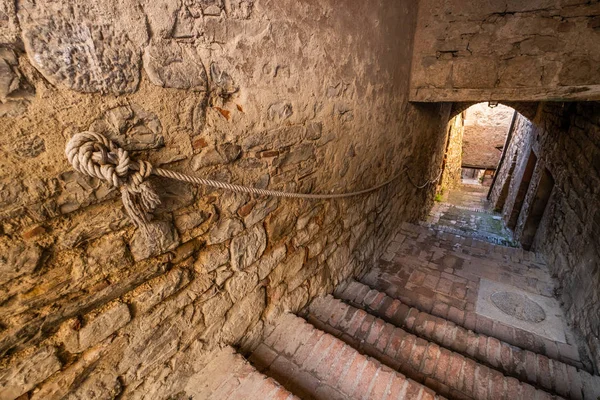 Typical internal road with stairways to reach the historical part of the medieval village of Suvereto, province of Livorno, Tuscany, Italy