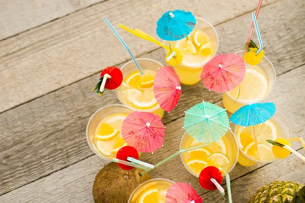 Summer citrus cocktail with umbrellas. Refreshing lemonade. View from above. Bright color.