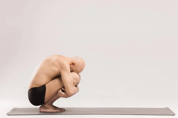 Man  figures doing yoga asanas. Yogi poses. A man makes a comple