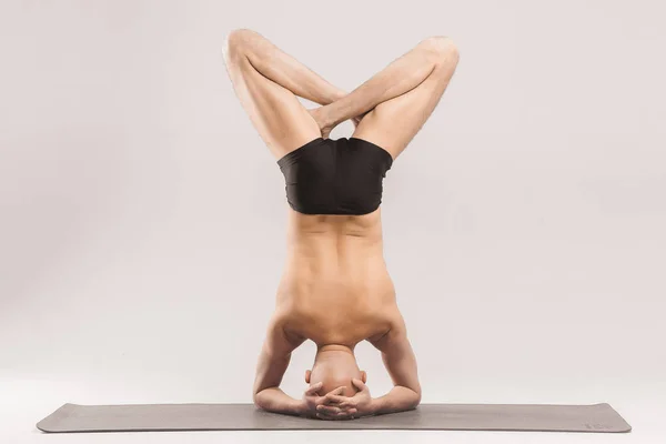 Man  figures doing yoga asanas. Yogi poses. A man makes a comple — Stock Photo, Image