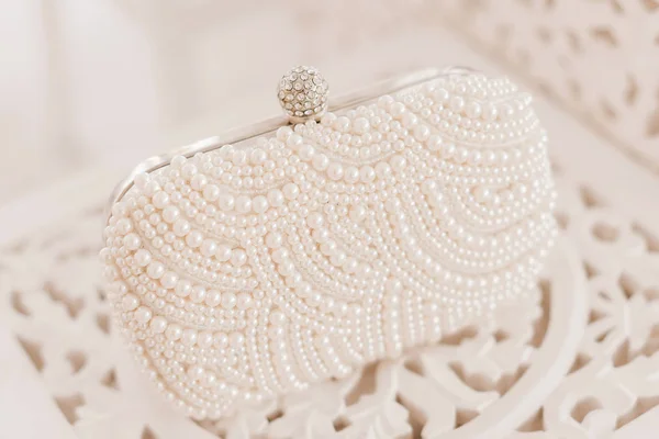 Fashionable wedding accessory. Pearl clutch (handbag) for an ele