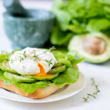 Yumurta-ciabatta ile haşlanmış, avokado ve bebek marul yaprakları.