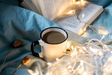 Yatakta kahve bardağı ve çelenk. Atmosferik Hygge tarzı. Rahat w