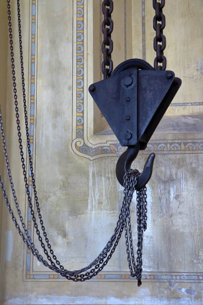 A detail of an antique rusty crane hook