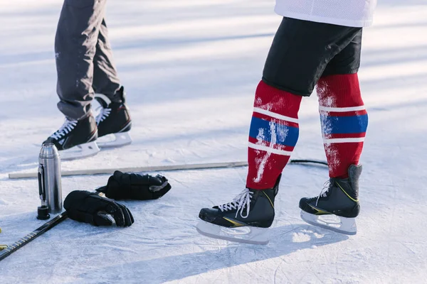 hockey player lying on the snow at the stadium