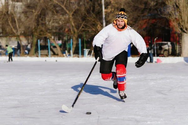 man in ice skates plays in hockey at the stadium