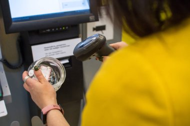 Alışveriş, satış, ödeme, tüketicilik ve insan kavramı. Kız bir mağaza veya süpermarket self-servis yazar kasa bir satın alma tarar
