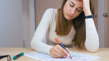 Evde gazete ilanları okuyan üzgün kadın.