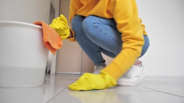 Mãos femininas usando luvas de borracha amarela limpeza cozinha — Vídeo de Stock