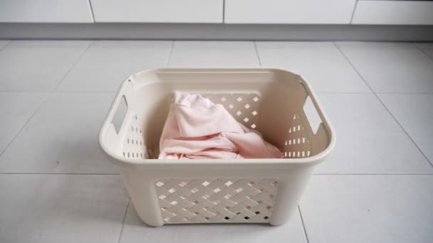 Lavandería. Cesta para ropa sucia, la preparación para un gran lavado, vista superior. ropa de cama blanca se lanza en la cesta de lavandería — Vídeos de Stock