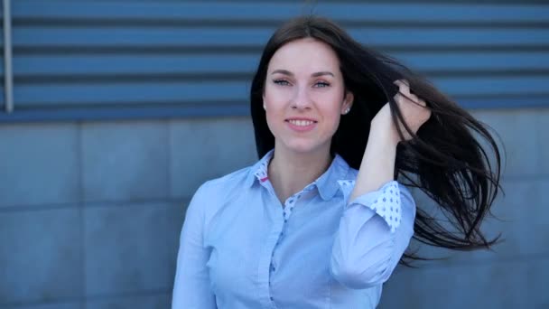 Una atractiva mujer posa para las cámaras femeninas endereza sus guiños de pelo y coquetea en City Background — Vídeos de Stock