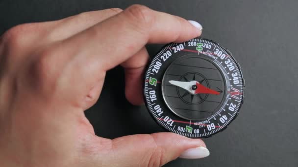 Närbild kompass med rörlig nål på toppen på svart bakgrund — Stockvideo