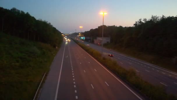 春の夕日の青空の下で高速道路を走行する車やトラック — ストック動画