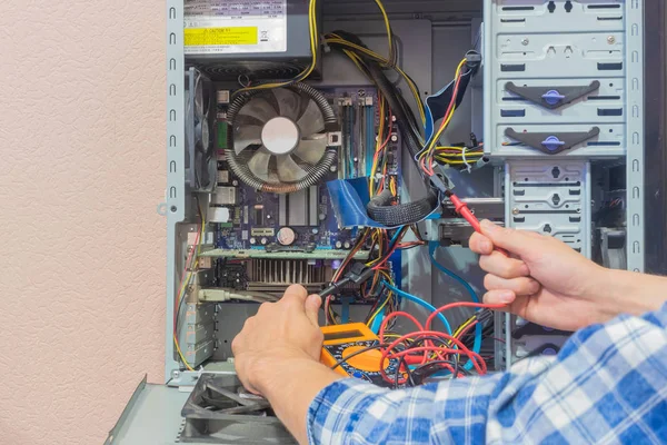 a man is repairing a computer