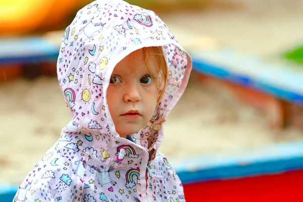 Красивая Девочка Дождевой Куртке Смотрит Капота Детскую Площадку Дождливый День — стоковое фото