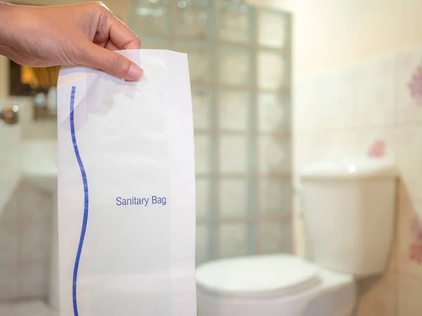 Woman Hand Holding Sanitary Bag Blurred Wate Closet Background Copy — Stock Photo, Image