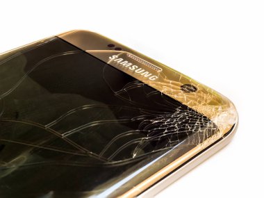 Chiangrai, Thailand: September 09, 2017 - Close-up image of cracked screen Samsung S7 edge smartphone cause of accident prepairing to repair on white backgroun clipart