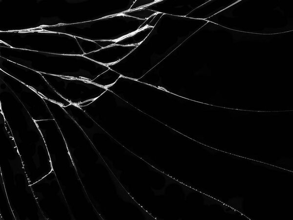 Cracked glass texture on black background. Isolated realistic cracked glass effect.