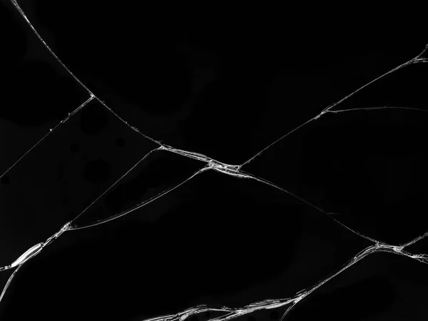 Cracked glass texture on black background. Isolated realistic cracked glass effect.