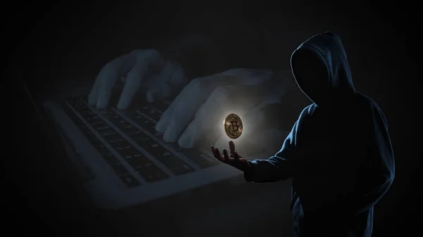 Golden Bitcoin floating above of hacker's hand in dark on hacker hacking with computer laptop background with copy space. Finance, business, e-commerce or cyber crime concept