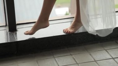 Gelin parapetin üzerinde bir kız bacakları