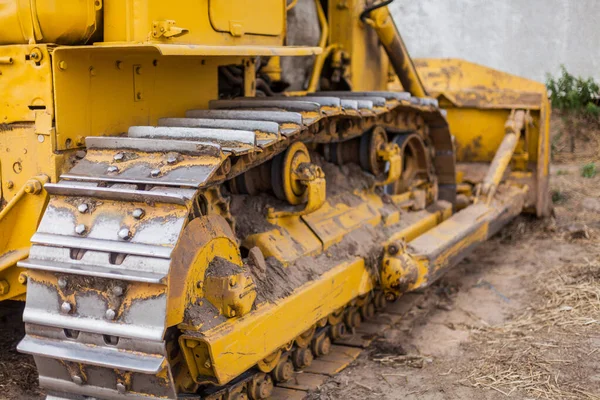 Yellow Tractor on crawler track. Close-up of crawler bulldozer truck. Earthmoving heavy machinery