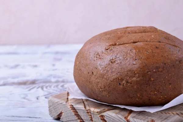 Rye whole grain flour dough formed into a round loaf ready to be baked