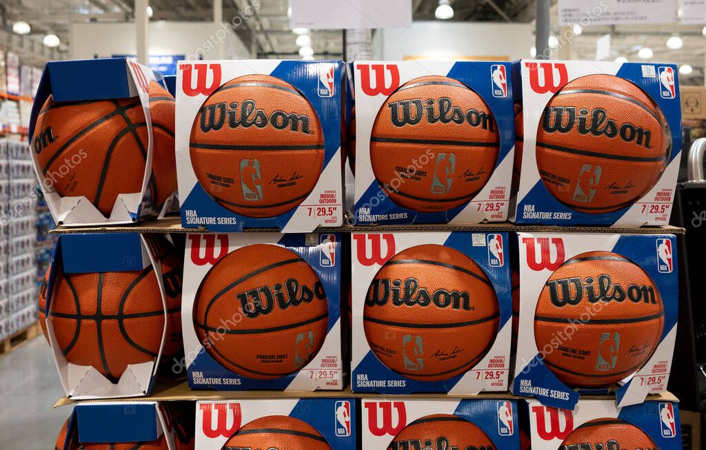 Wilson basketballs are displayed and sold in the sports section of a supermarket.