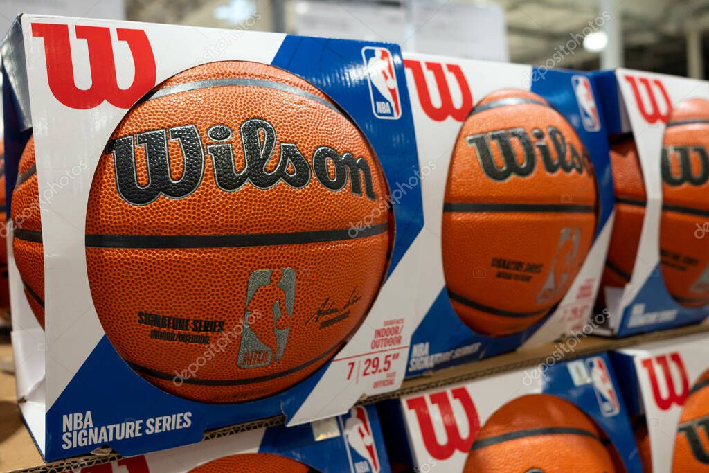 Wilson basketballs are displayed and sold in the sports section of a supermarket.