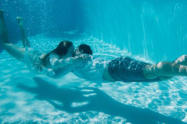 Man and woman kissing under the water, Malta clipart
