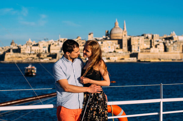 Man and woman embrace, Valletta and sea on backround, Malta