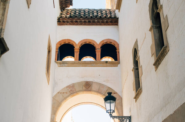 Old street with arch in Sitges, Spain